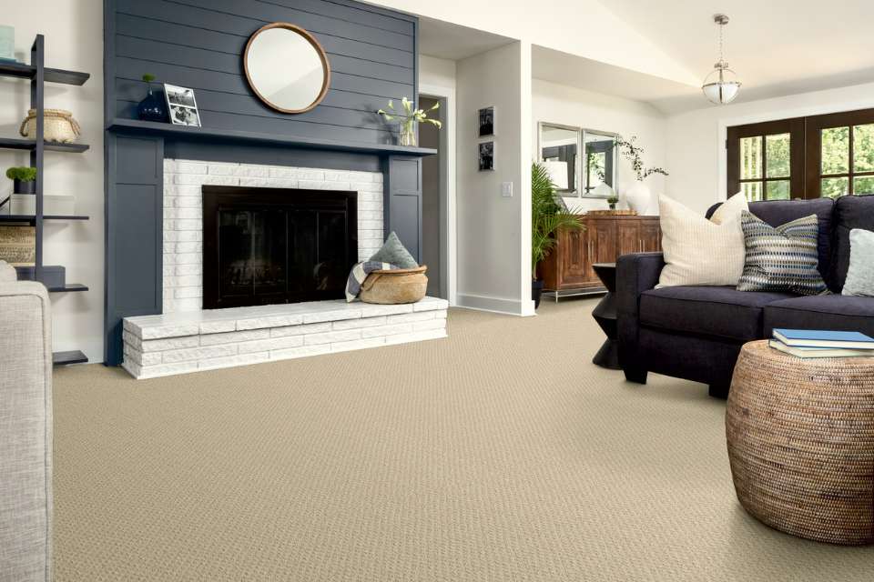 beige patterned nylon carpet in modern farmhouse living room with blue accent fireplace